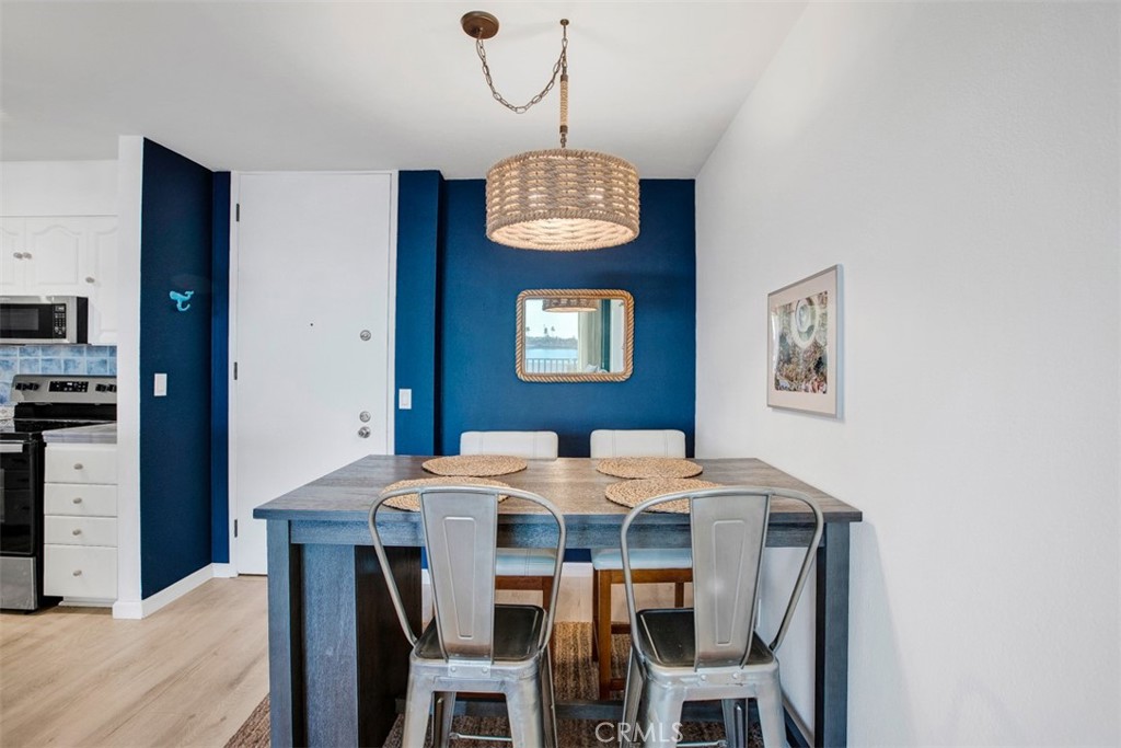 1140 East Ocean Boulevard, Unit 235 Long Beach, CA 90802 - Photo 11 of 45 a dining room with a table and chairs