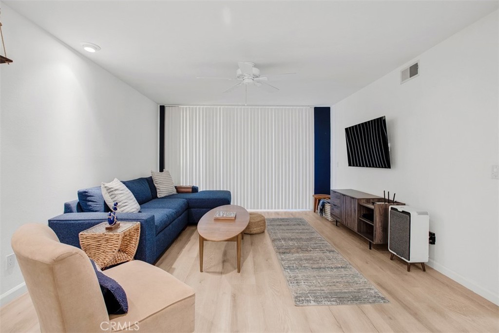 1140 East Ocean Boulevard, Unit 235 Long Beach, CA 90802 - Photo 19 of 45 a living room with furniture a flat screen tv and kitchen view