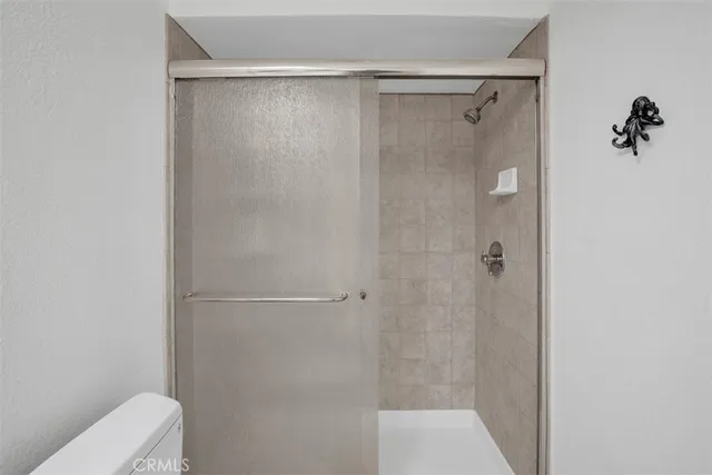 a bedroom with a bed and a night stand