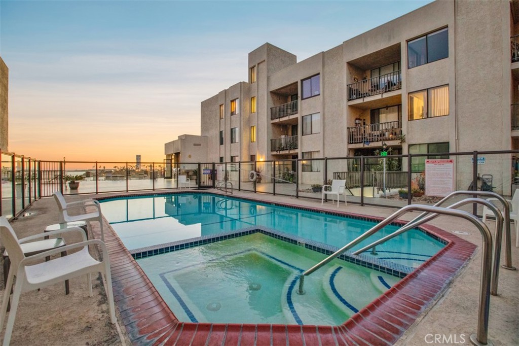 1140 East Ocean Boulevard, Unit 235 Long Beach, CA 90802 - Photo 27 of 45 a view of a swimming pool with a lounge chair