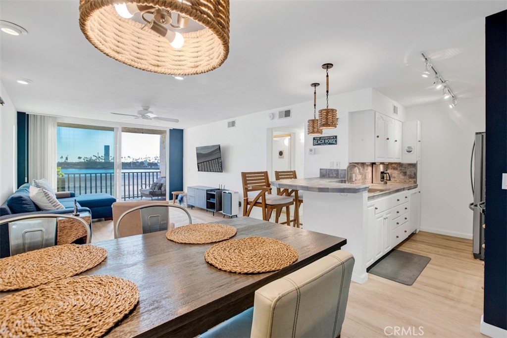 1140 East Ocean Boulevard, Unit 235 Long Beach, CA 90802 - Photo 6 of 45 a large kitchen with kitchen island a large counter top space a sink stainless steel appliances and cabinets