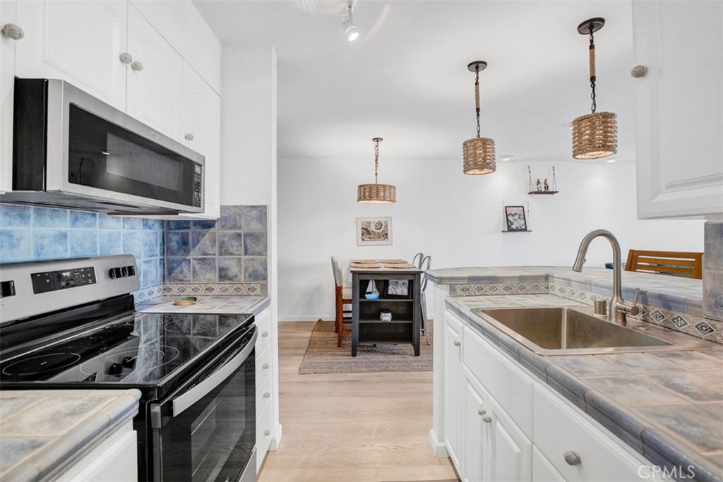 1140 East Ocean Boulevard, Unit 235 Long Beach, CA 90802 - Photo 9 of 45 a kitchen with a stove and a sink