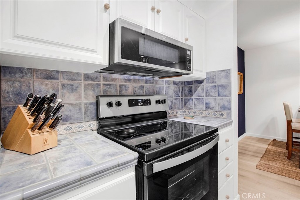 1140 East Ocean Boulevard, Unit 235 Long Beach, CA 90802 - Photo 10 of 45 a kitchen with a stove and a microwave