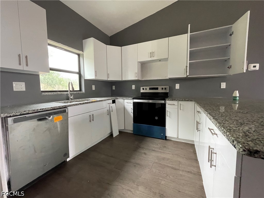 8046 Memory Circle LaBelle, FL 33935 - Photo 2 of 10 a kitchen with a sink stove and cabinets