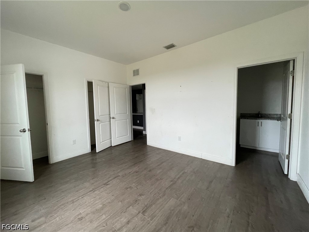 8046 Memory Circle LaBelle, FL 33935 - Photo 5 of 10 an empty room with wooden floor and closet