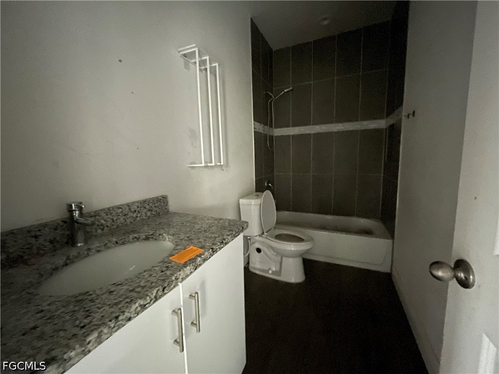 8046 Memory Circle LaBelle, FL 33935 - Photo 6 of 10 a bathroom with a granite countertop sink and a mirror