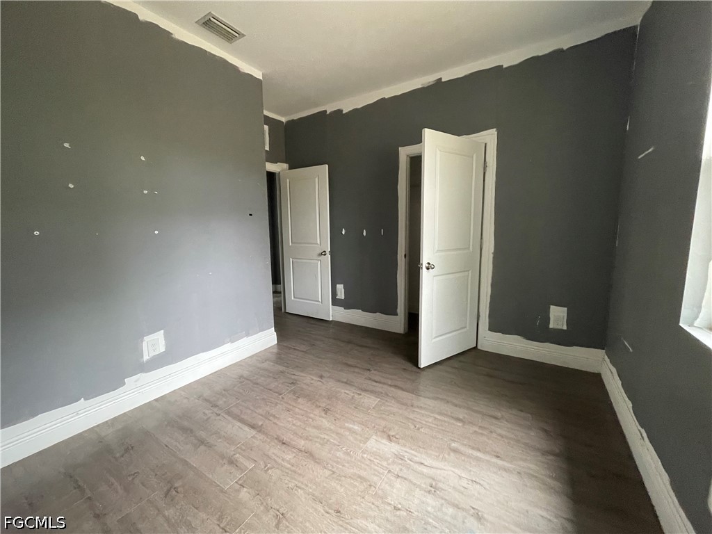 8046 Memory Circle LaBelle, FL 33935 - Photo 10 of 10 an empty room with wooden floor and windows