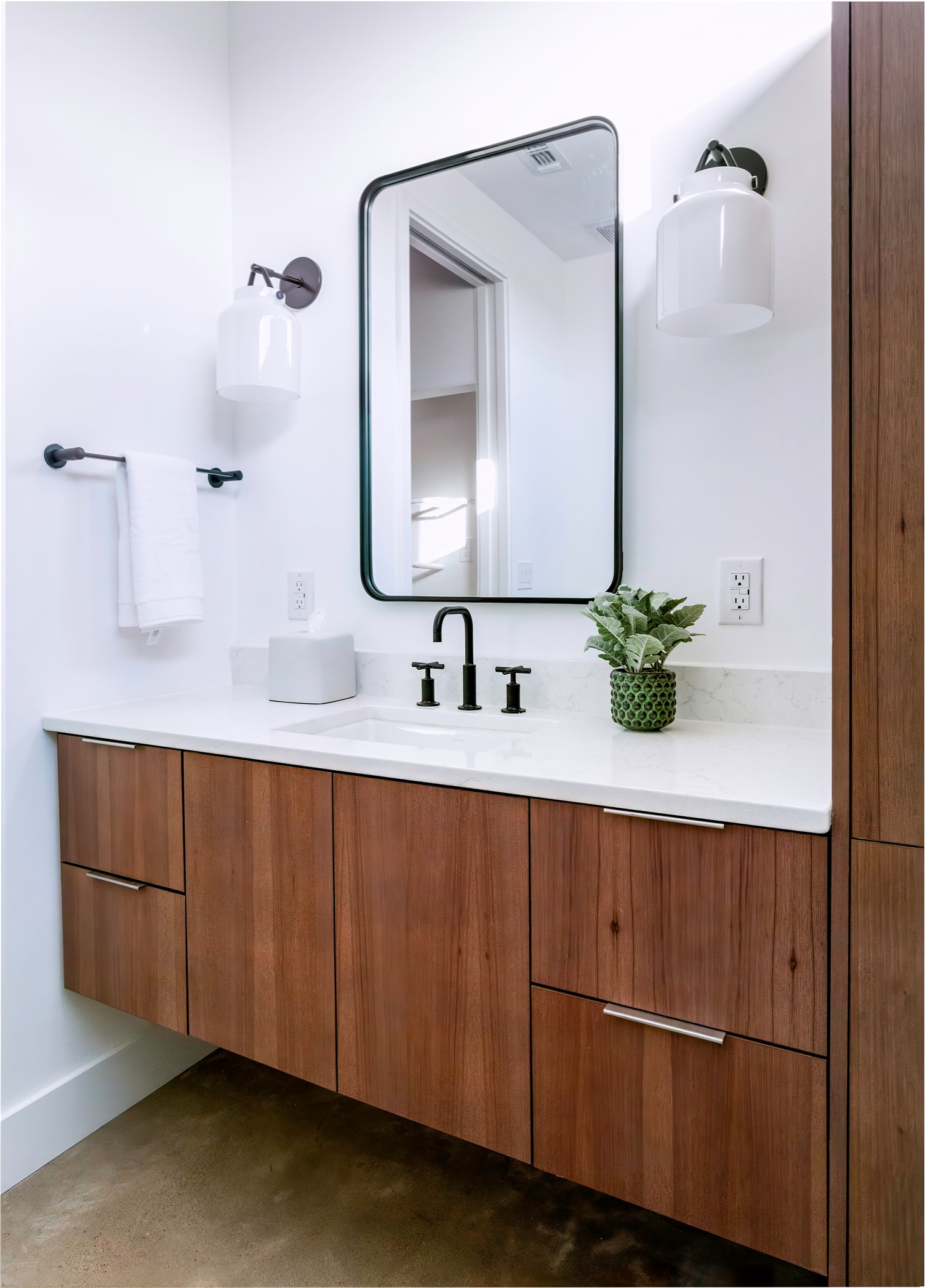 312 Hye Springs Road, Unit 106 Hye, TX 78635 - Photo 6 of 17 Elegant vanity area with custom cabinetry, quartz countertops, and sleek black hardware for a refined modern look.