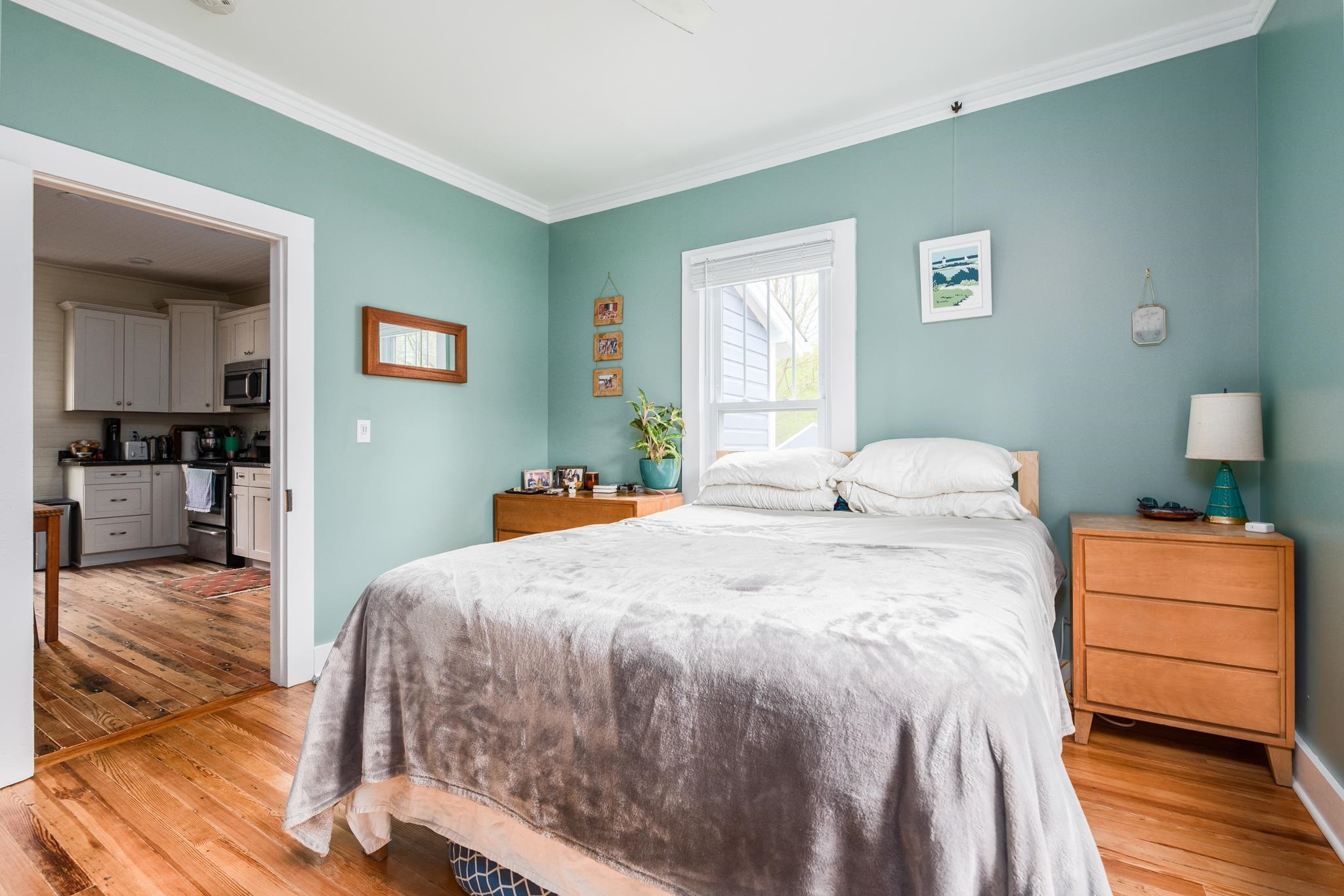 1112 Berkeley Street Durham, NC 27705 - Photo 11 of 23 a bedroom with a bed and wooden floor