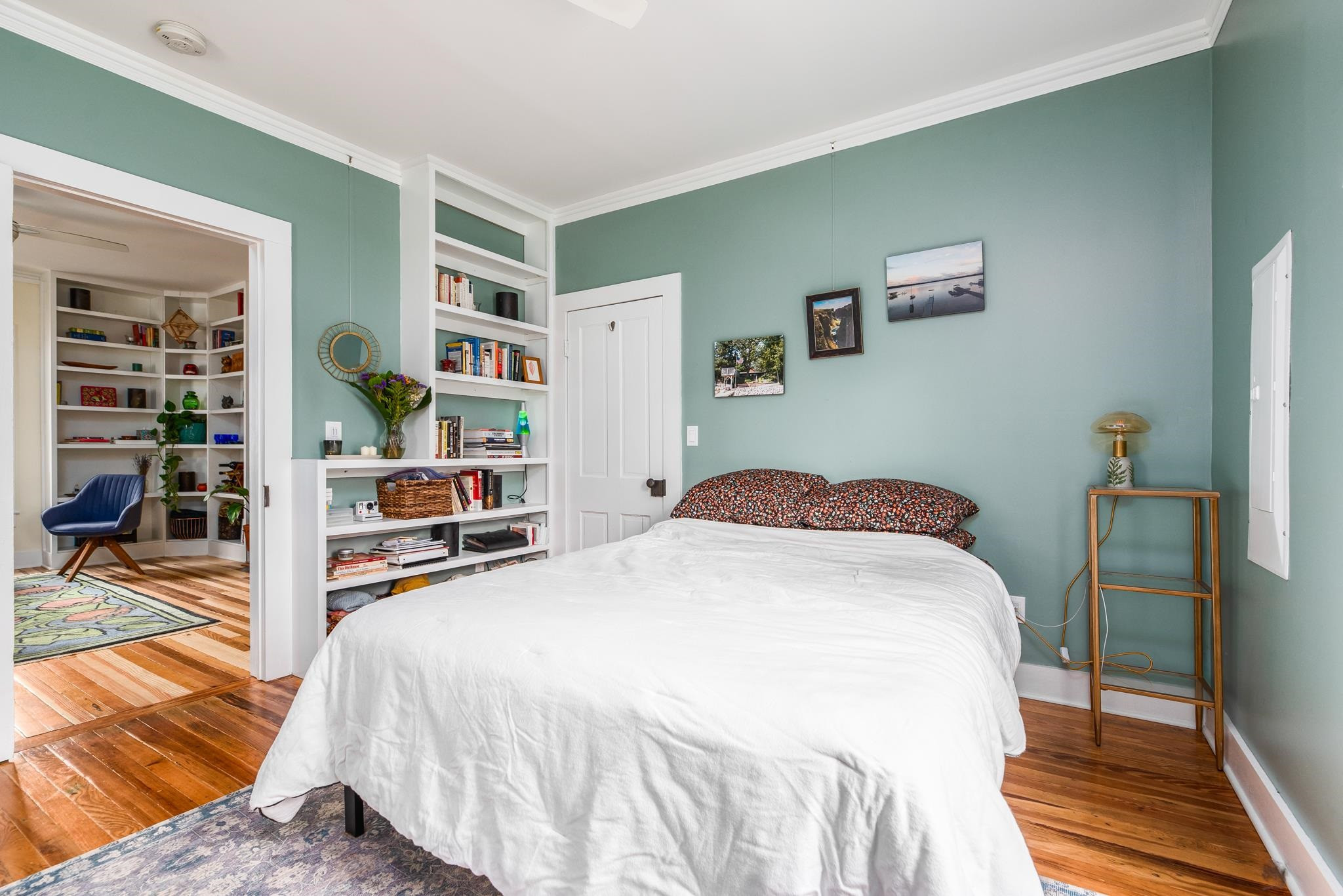 1112 Berkeley Street Durham, NC 27705 - Photo 12 of 23 a bedroom with a bed and a book shelf