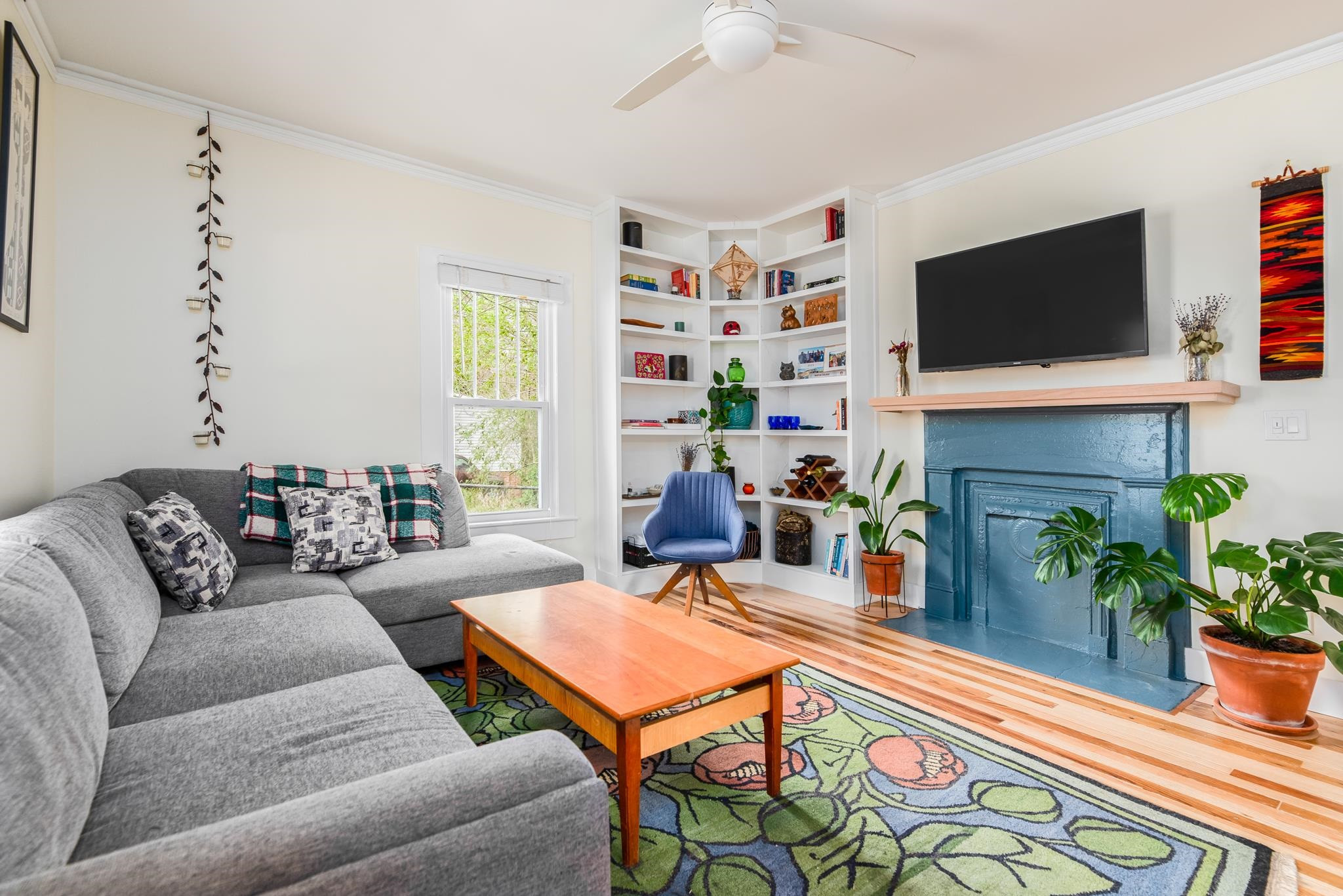 1112 Berkeley Street Durham, NC 27705 - Photo 3 of 23 a living room with furniture a flat screen tv and a fireplace