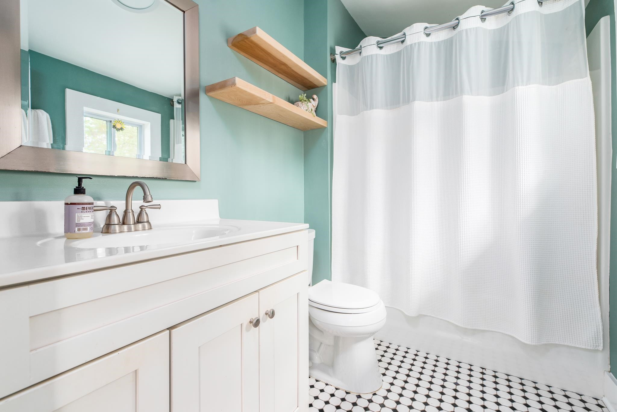 1112 Berkeley Street Durham, NC 27705 - Photo 10 of 23 a bathroom with a sink toilet and shower