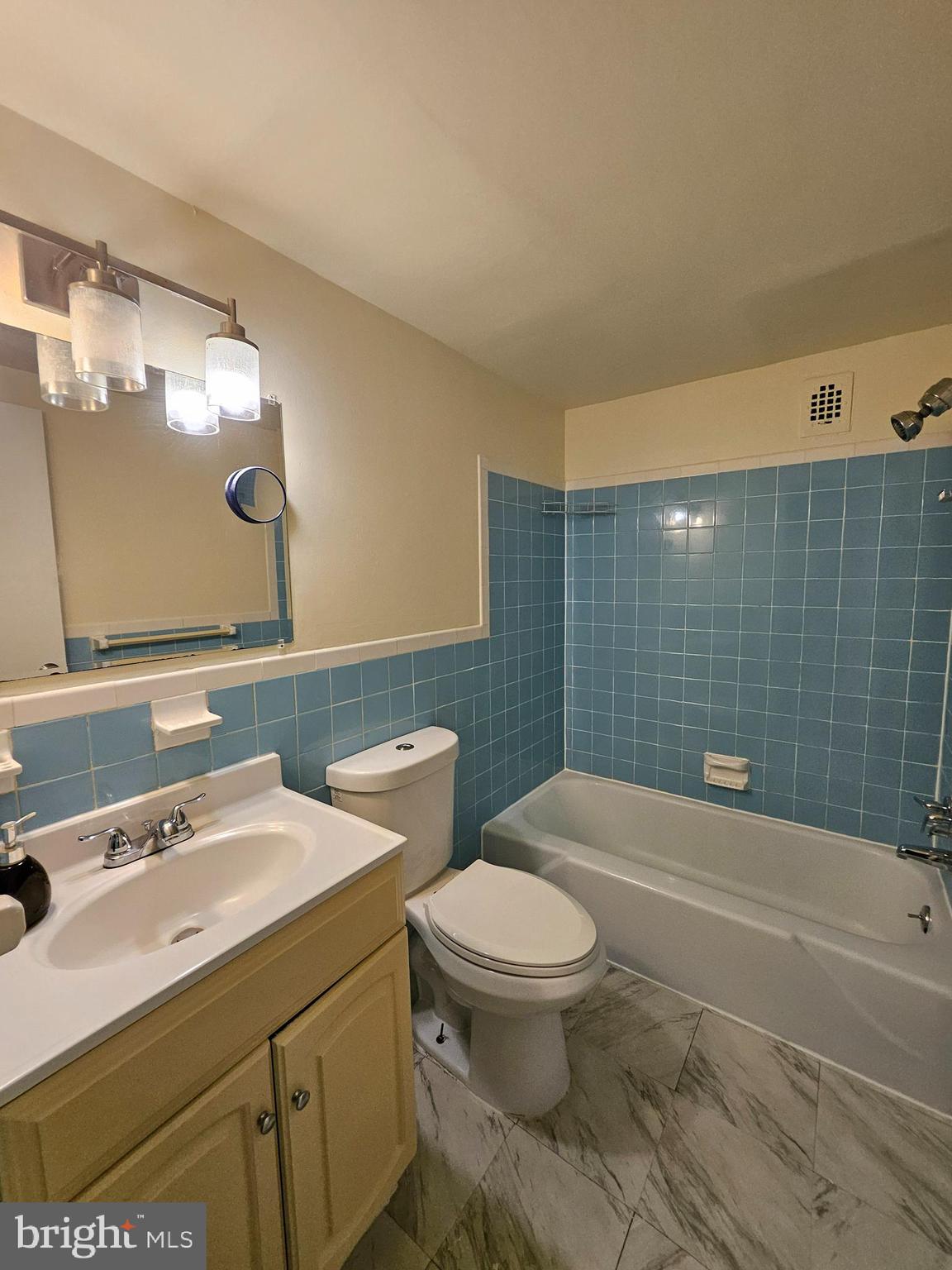 3450 Toledo Terrace, Unit 522 Hyattsville, MD 20782 - Photo 12 of 17 a bathroom with a sink a toilet and a mirror