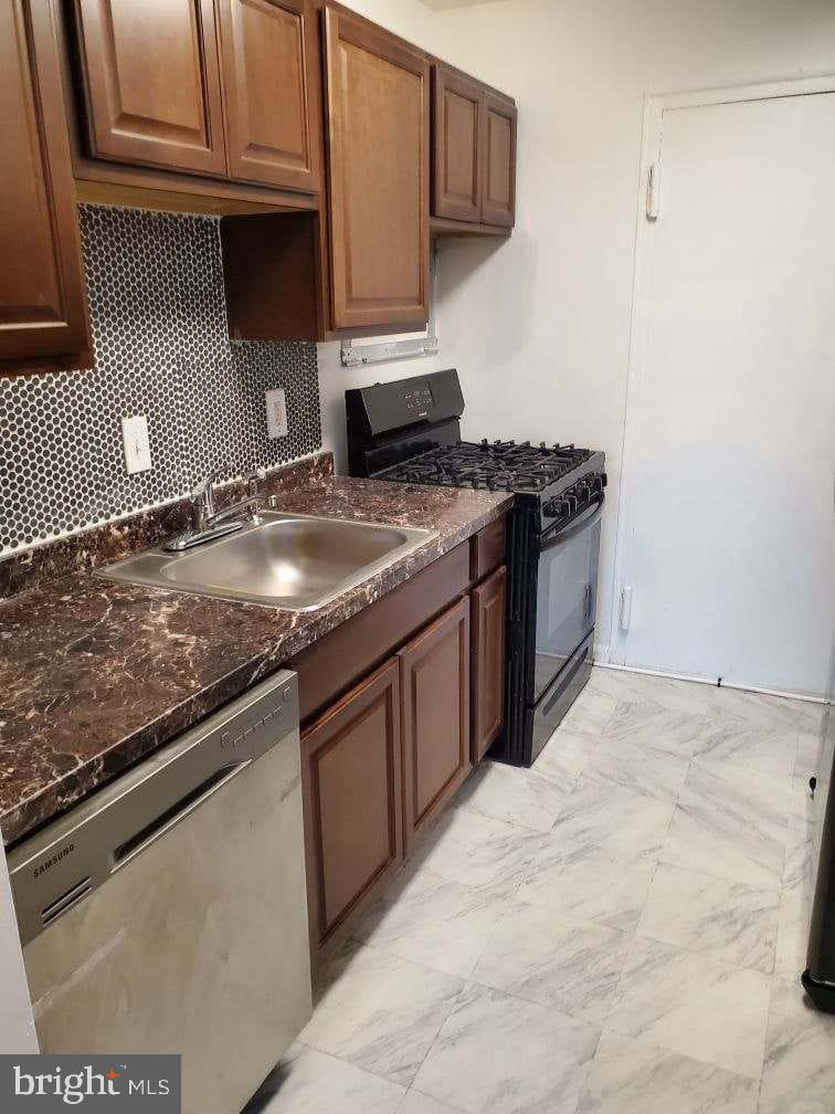 3450 Toledo Terrace, Unit 522 Hyattsville, MD 20782 - Photo 15 of 17 a kitchen with granite countertop a sink and a stove