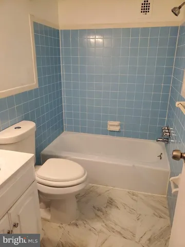a bathroom with a toilet and bathtub