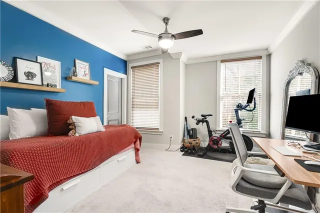 a bedroom with a bed and a desk