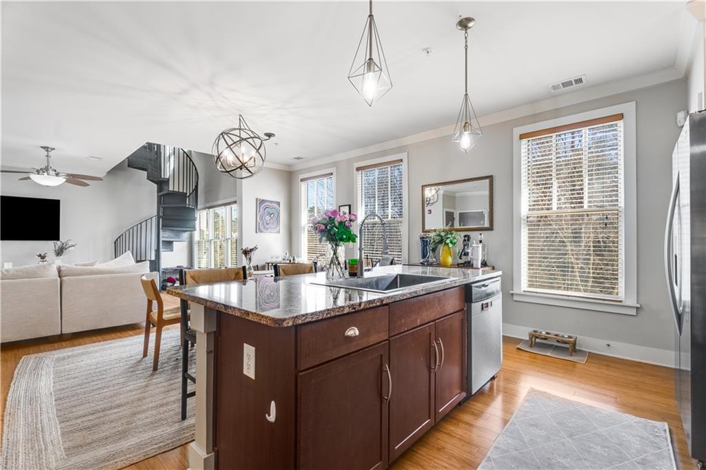1628 Briarcliff Road Northeast, Unit 18 Atlanta, GA 30306 - Photo 7 of 25 a kitchen with granite countertop a sink a counter space appliances and cabinets