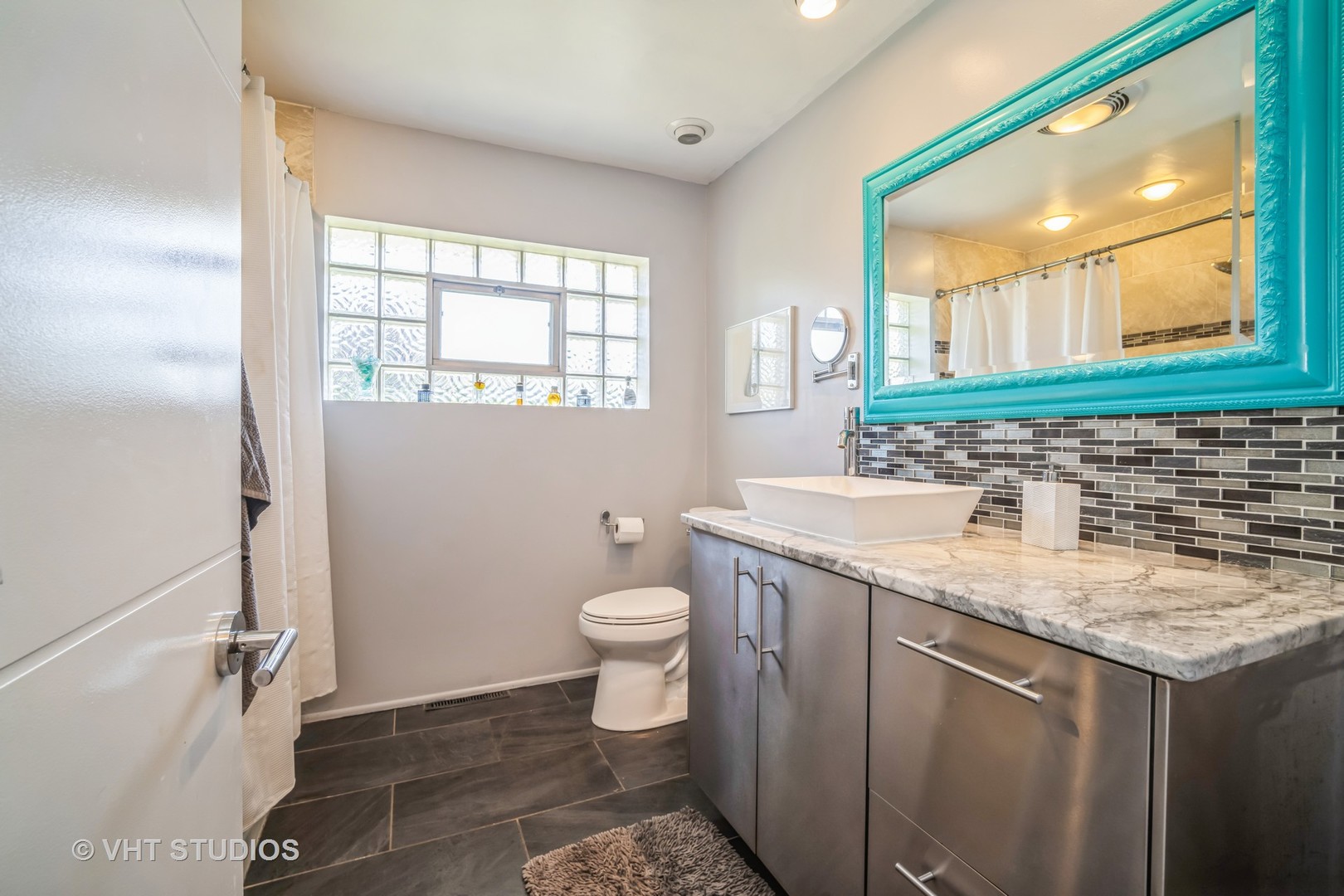 135 Birchwood Road Northbrook, IL 60062 - Photo 12 of 20 a bathroom with a granite countertop sink toilet and mirror