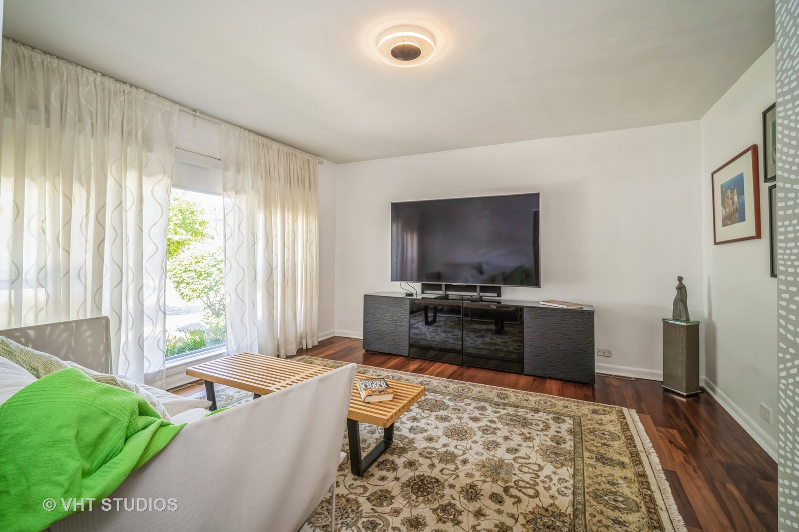 135 Birchwood Road Northbrook, IL 60062 - Photo 5 of 20 a living room with a couch and a flat screen tv