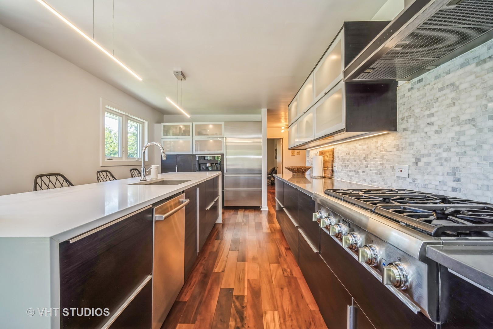 135 Birchwood Road Northbrook, IL 60062 - Photo 9 of 20 a kitchen with stainless steel appliances granite countertop a stove a sink and a refrigerator
