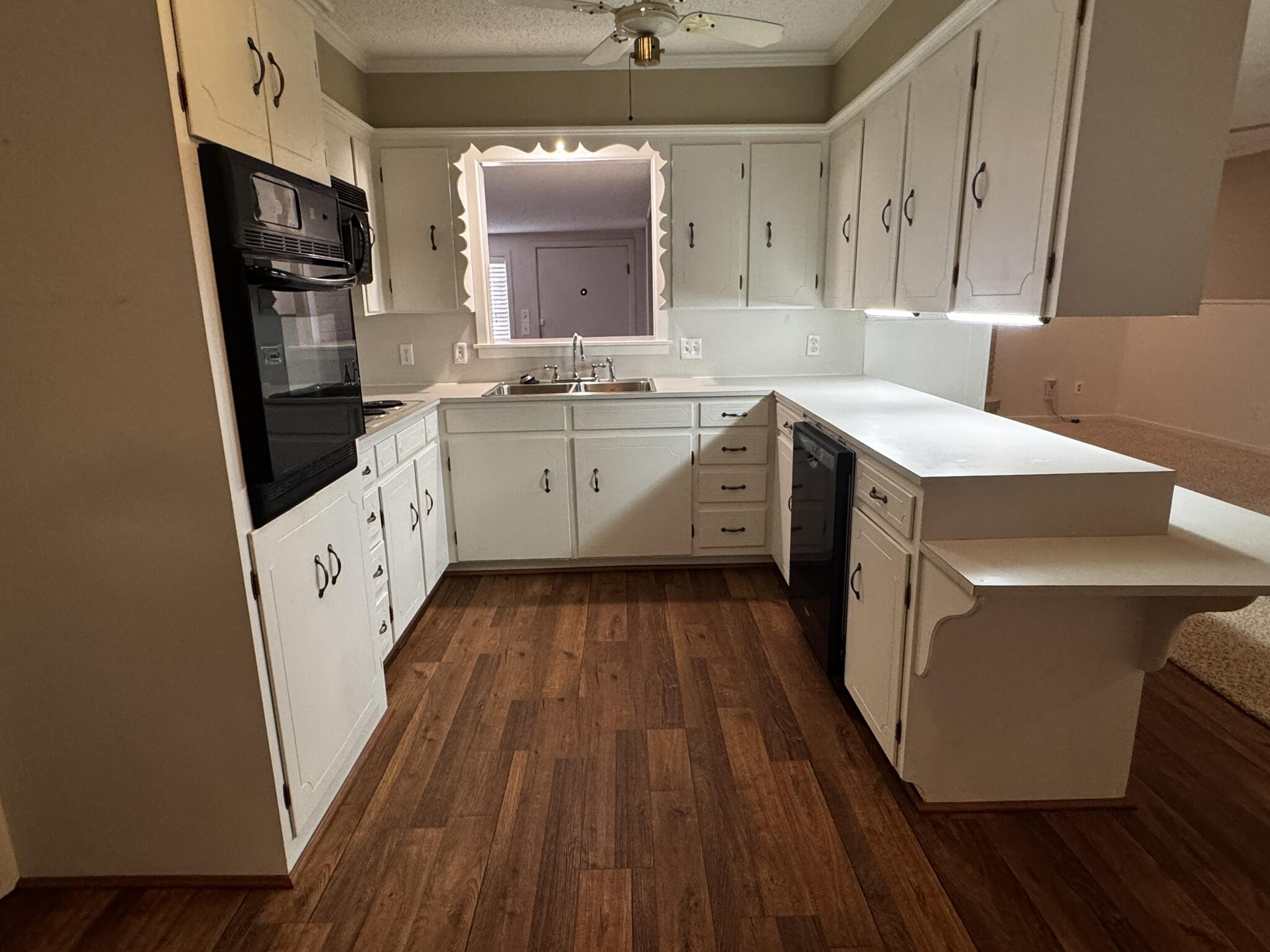 1304 Floydada Plainview, TX 79072 - Photo 15 of 49 a kitchen with sink a refrigerator and cabinets