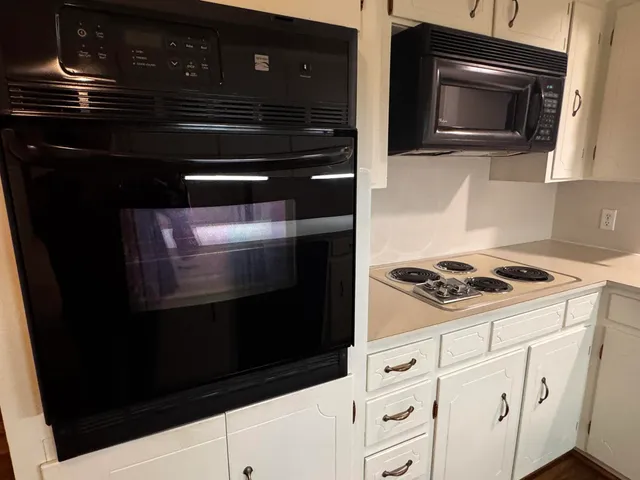 a kitchen with granite countertop cabinets and steel stainless steel appliances