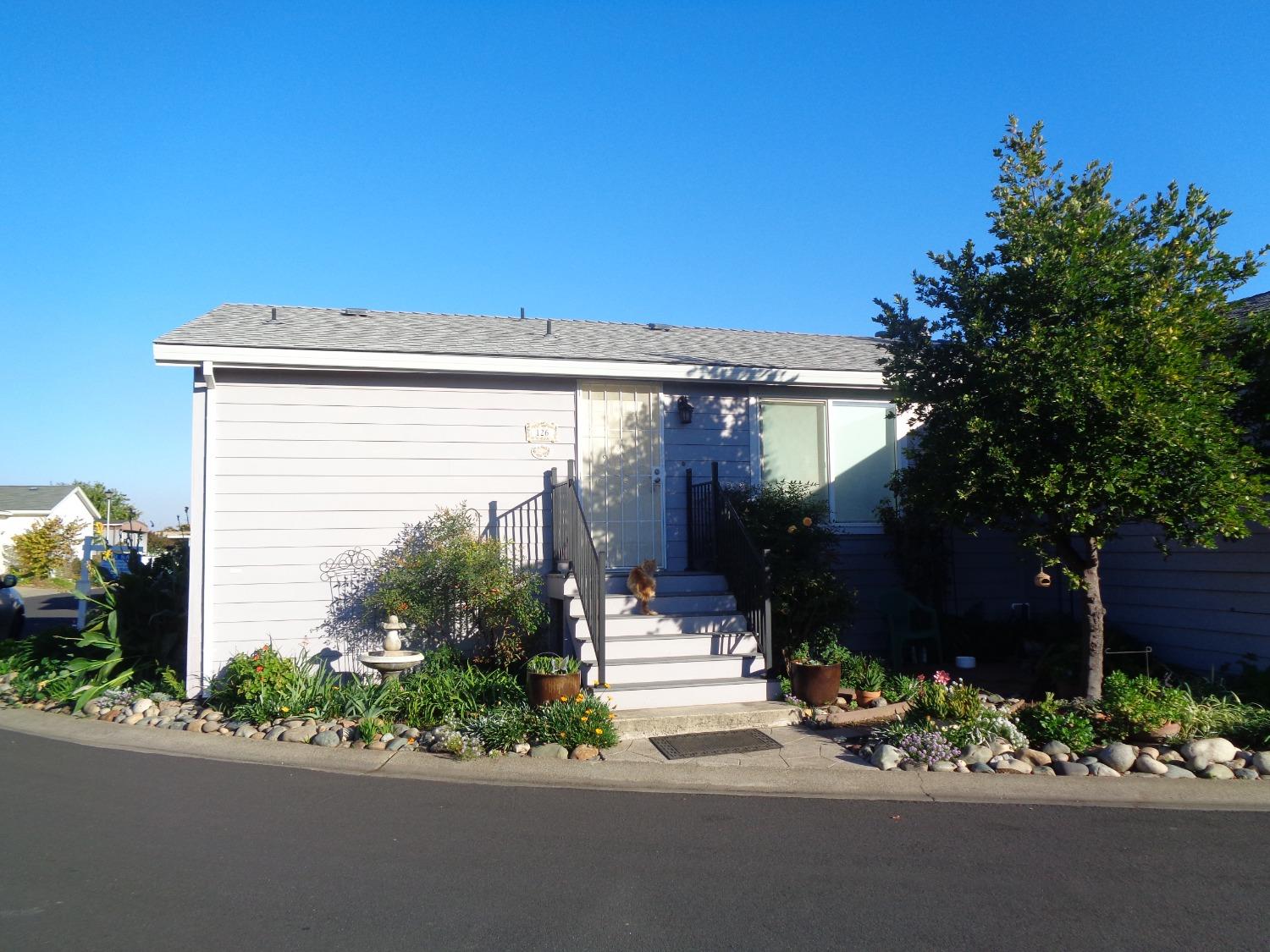 a front view of a house with a garden