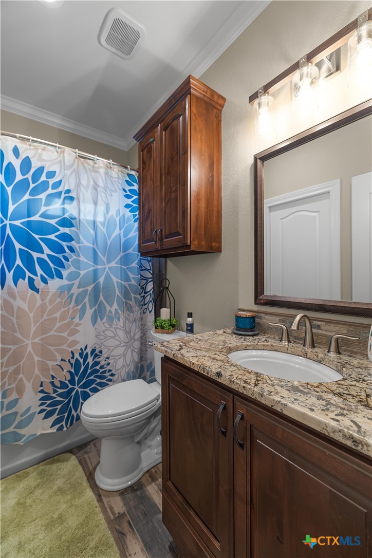 254 Sendera Loop Victoria, TX 77904 - Photo 35 of 48 a bathroom with a granite countertop toilet sink and mirror