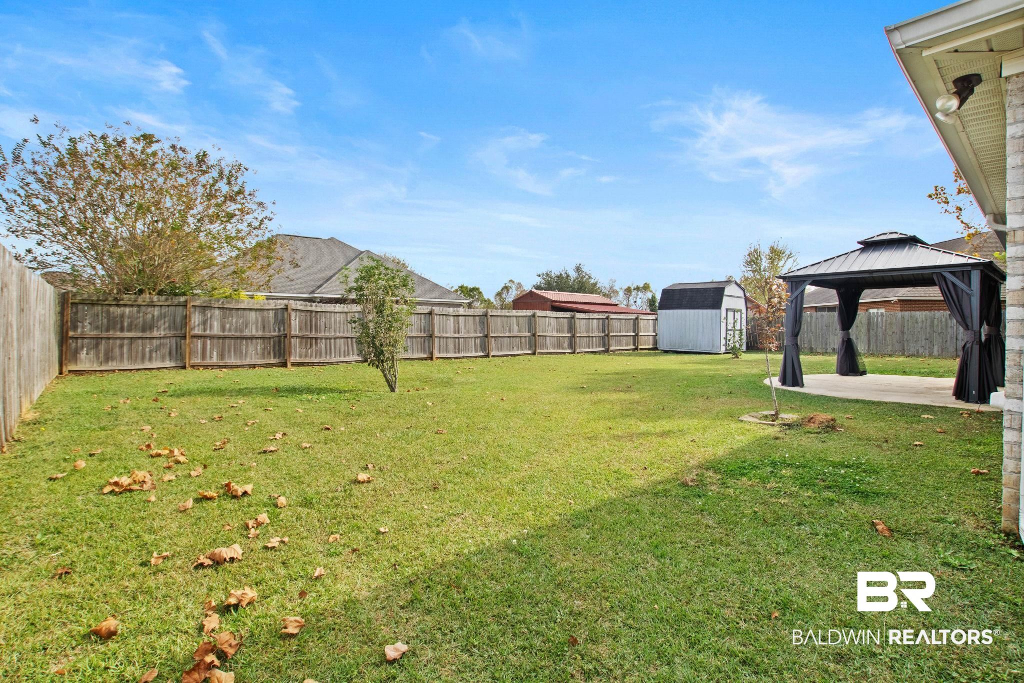 17376 Bankhead Boulevard Fairhope, AL 36532 - Photo 63 of 73 Fenced backyard with a shed, a patio area, and a gazebo
