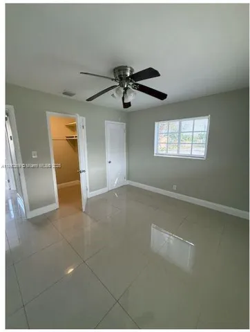 a view of a livingroom with a ceiling fan and window