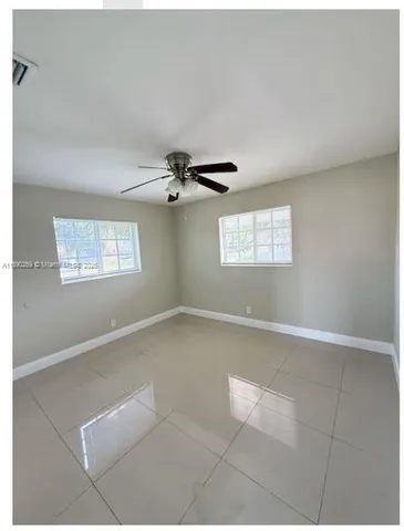 a view of a livingroom with a ceiling fan and window