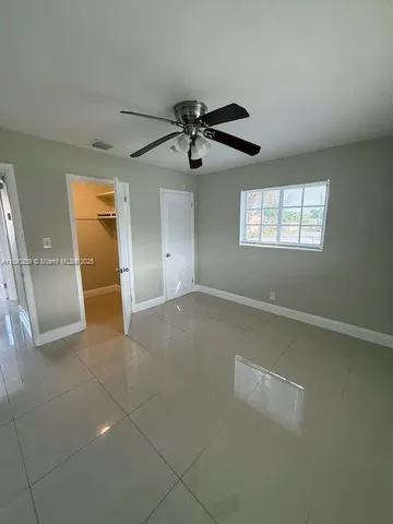 a view of a livingroom with a ceiling fan and window