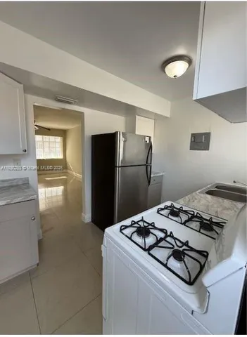 a kitchen with a stove and a refrigerator