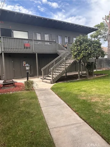 a swimming pool with outdoor seating and yard