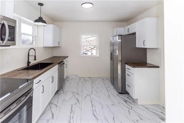 a kitchen with a sink stove and refrigerator