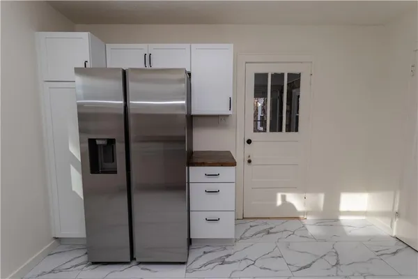 a kitchen with stainless steel appliances cabinets and an oven
