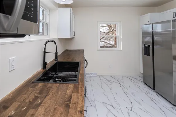 a view of kitchen with stainless steel appliances cabinets and a counter top space