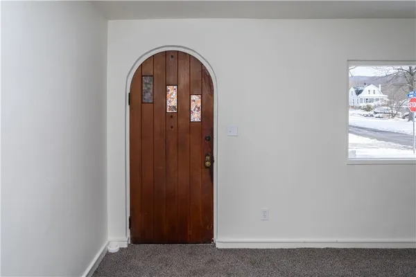a view of front door with chandelier