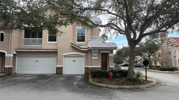 a front view of a house with a yard garage and outdoor seating