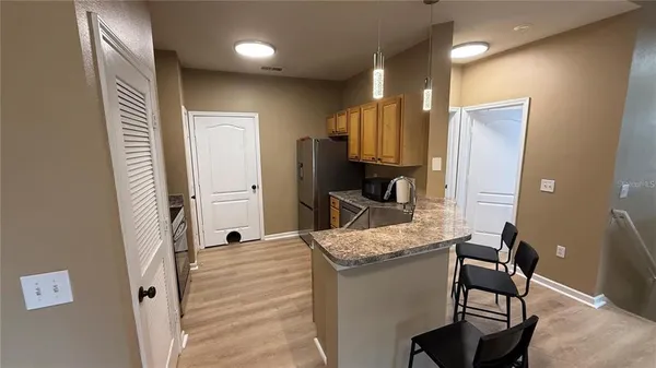 a bathroom with a granite countertop sink a mirror and a shower
