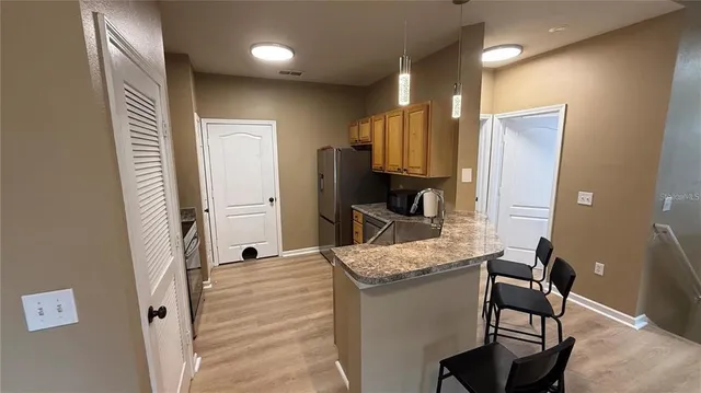a bathroom with a granite countertop sink a mirror and a shower