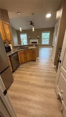a large kitchen with stainless steel appliances kitchen island a large counter top a stove and a refrigerator