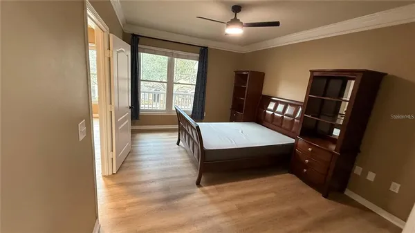 a bedroom with a bed and a large window