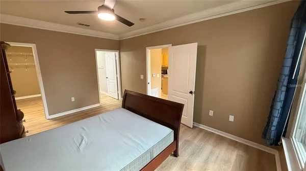 a room with a bed and wooden floor
