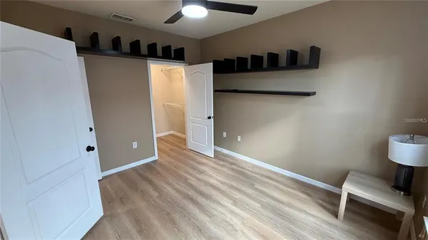 a view of a room with wooden floor
