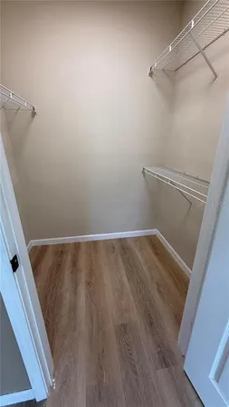 a view of a hallway view with wooden floor and furniture
