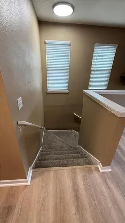 a view of a room with wooden floor and white walls