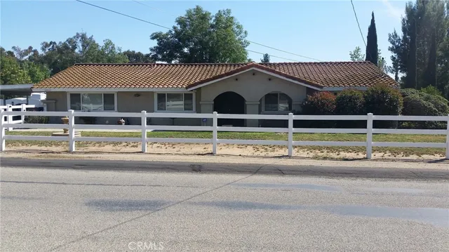 a view of a house with a yard and sitting area