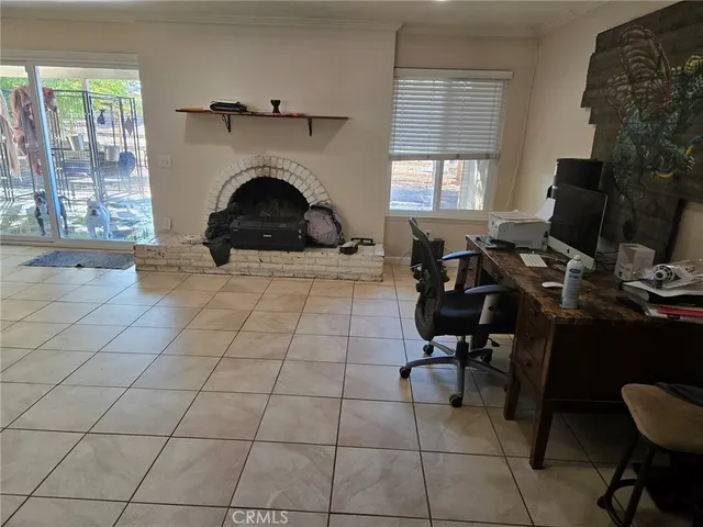 a living room with furniture a fireplace and large windows