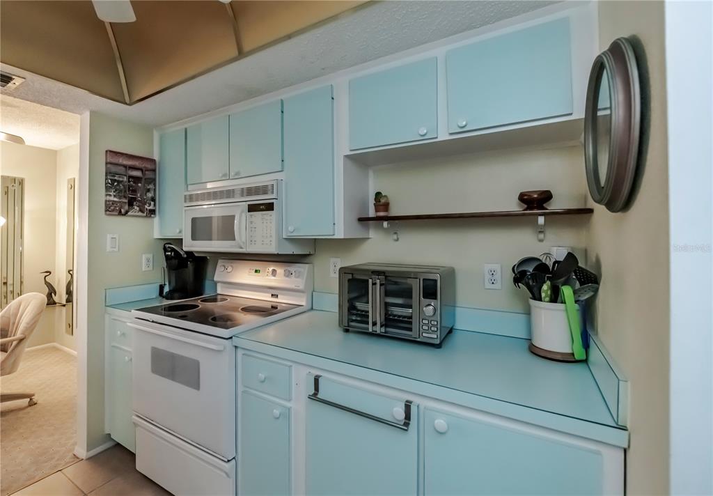 22375 Edgewater Drive, Unit 238 Punta Gorda, FL 33980 - Photo 16 of 57 a kitchen with a white stove and cabinets
